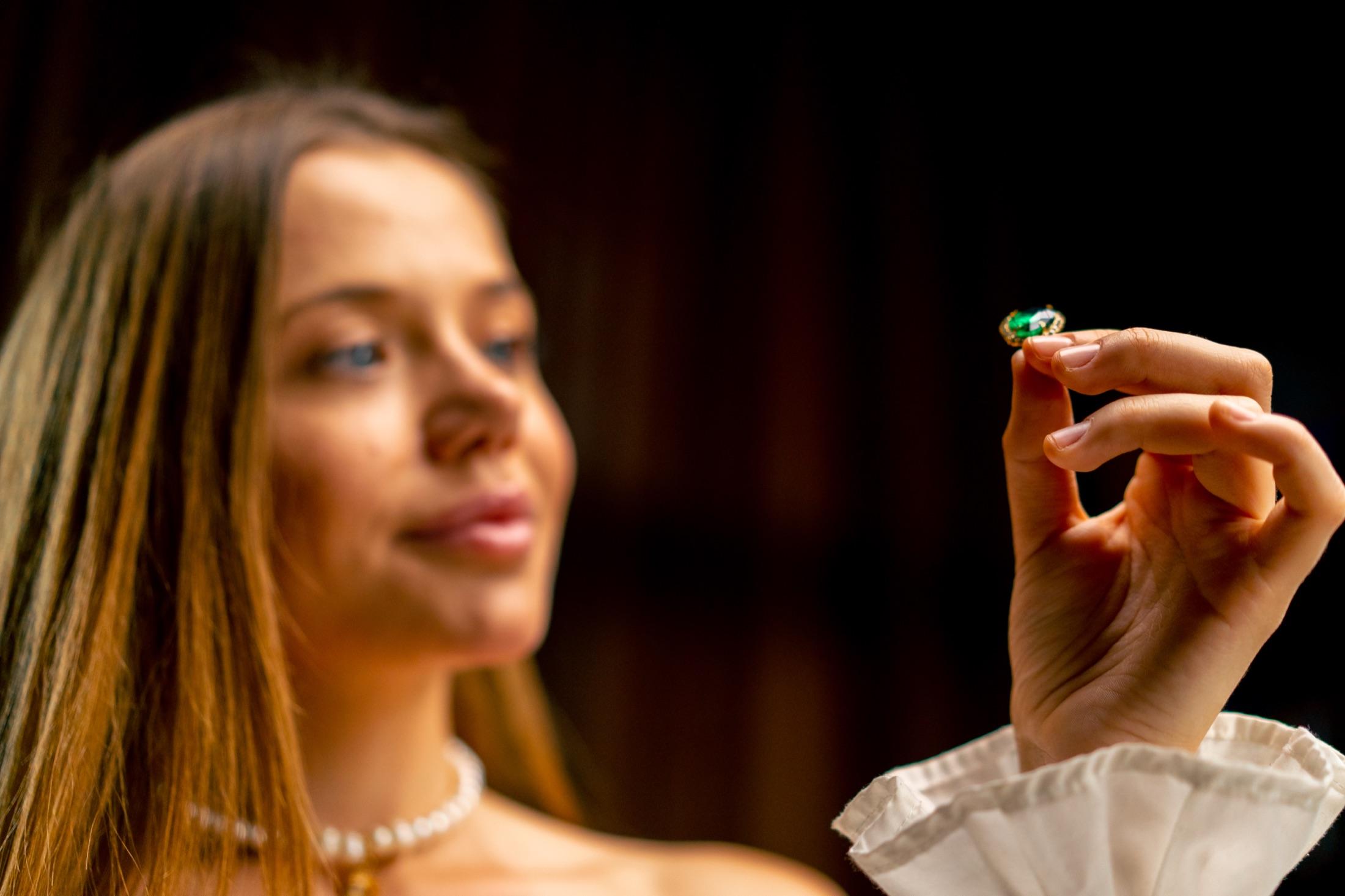 Gemologist carefully examining a stone under light
